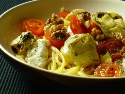 Pasta with mozarella, tomatoes and antipasti